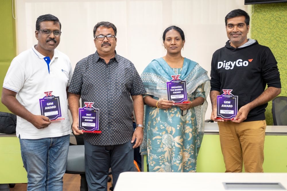 Large group photo with certificates in professional setting