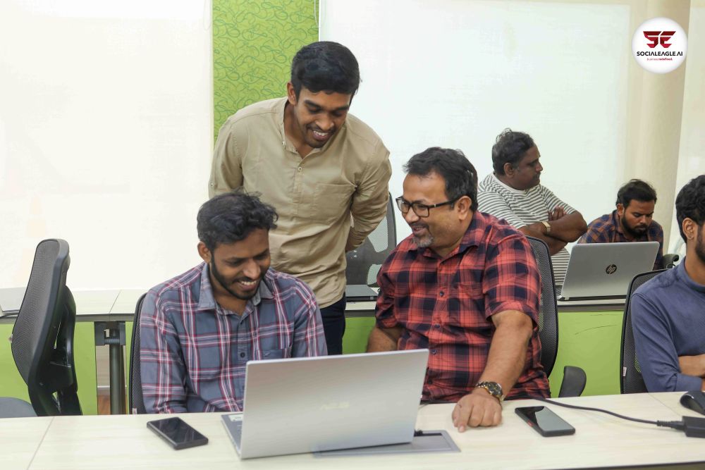 Three men collaborating around laptops in learning environment